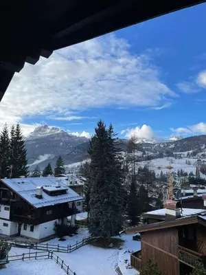 a view of a snowy mountain from a house at Cortina central apartment overlooking Tofane Faloria in Cortina dʼAmpezzo