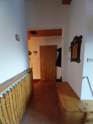 a room with a staircase and a wooden bench at Casa Claudia in Carano