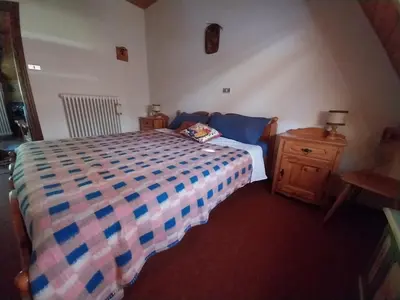 a bedroom with a bed and a night stand at Casa Claudia in Carano