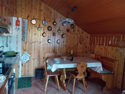 a kitchen with a table and chairs in a room at Casa Claudia in Carano