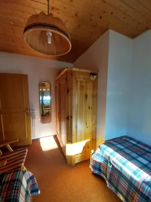 a bedroom with two beds and a wooden ceiling at Casa Claudia in Carano