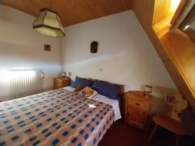 a bedroom with a bed and two night stands at Casa Claudia in Carano