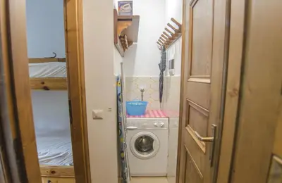 a small bathroom with a washing machine in a room at Ca Masarie in Alvera