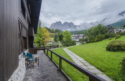 a balcony with chairs and a view of a mountain at Ca Masarie in Alvera