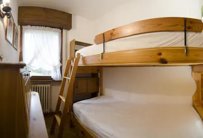 two bunk beds in a small room with a ladder at Ca Masarie in Alvera