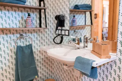 a bathroom with a sink and a blue towel at Wohnung ASSUNTA in Soprabolzano