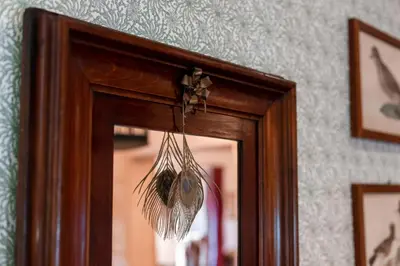 a mirror with a dream catcher hanging from it at Wohnung ASSUNTA in Soprabolzano