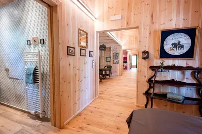 a hallway with wooden walls and wooden floors and a room at Wohnung ASSUNTA in Soprabolzano