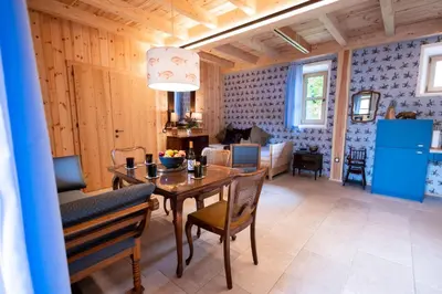 a dining room and living room with a table and chairs at Wohnung GEORG-OTTO in Soprabolzano