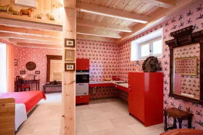 a kitchen with red cabinets and a red refrigerator at Wohnung PAUL in Soprabolzano
