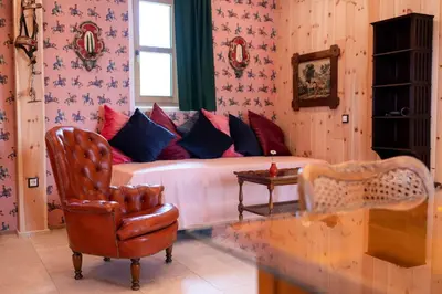a living room with a couch and a chair at Wohnung PAUL in Soprabolzano