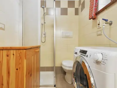 a washing machine in a bathroom with a toilet at Apartment Apt 1 by Interhome in Penia