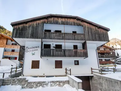 a building with a balcony in the snow at Apartment Apt 1 by Interhome in Penia