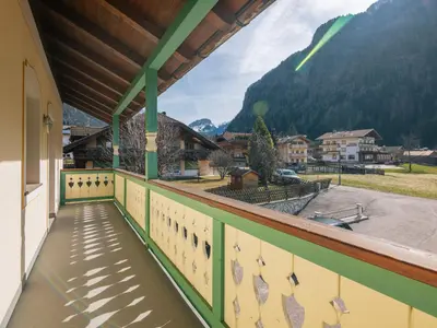 a balcony with a view of a field and mountains at Apartment Ardoney-2 by Interhome in Canazei