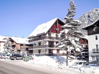 a pile of snow next to a fence at Apartment Marmolada-12 by Interhome in Alba di Canazei