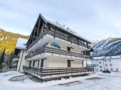 a pile of snow in front of a house at Apartment Marmolada-12 by Interhome in Alba di Canazei