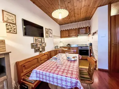 a kitchen with a table with a table cloth on it at Apartment Marmolada-12 by Interhome in Alba di Canazei
