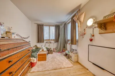 a room with a childs bedroom with a crib and a room with a room at Luxchalet a pochi minuti dal centro in Cortina dʼAmpezzo