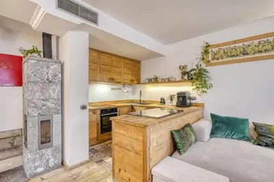 a living room with a couch and a kitchen at Luxchalet a pochi minuti dal centro in Cortina dʼAmpezzo