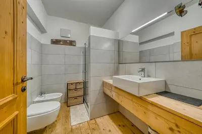 a bathroom with a sink and a toilet and a sink at Luxchalet a pochi minuti dal centro in Cortina dʼAmpezzo
