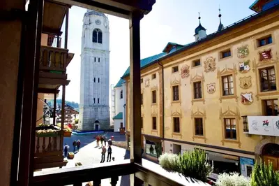 a view from a window of a street with two towers at Corso Italia Apartment - Magical view of the Dolomites in Cortina dʼAmpezzo
