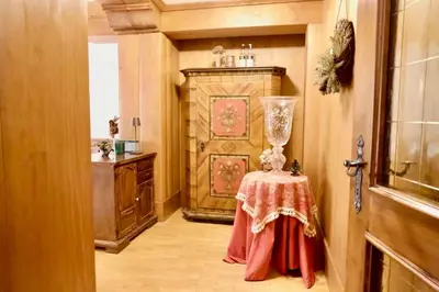 a room with a table with a vase on it at Corso Italia Apartment - Magical view of the Dolomites in Cortina dʼAmpezzo