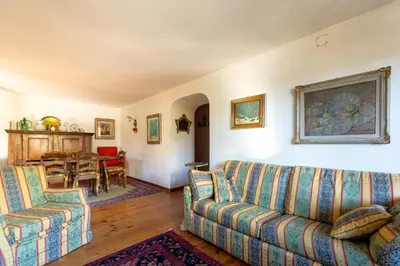 a living room with two couches and a table at Villa Diana in Cortina dʼAmpezzo