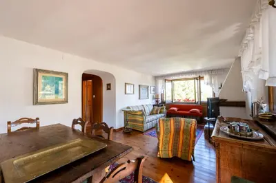 a living room with a table and a couch at Villa Diana in Cortina dʼAmpezzo