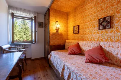 a small room with a bed and a window at Villa Diana in Cortina dʼAmpezzo