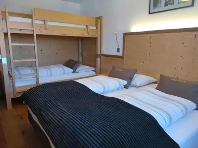 a room with three bunk beds and a bed at Chi Plans in Antermoia