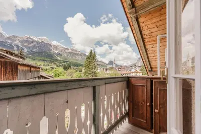a balcony with a view of the mountains at Ca' Alpini - Mountain View Terrace & Parking in Cortina dʼAmpezzo