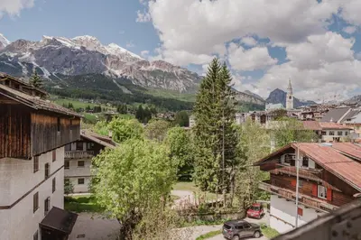a view of a town with mountains in the background at Ca' Alpini - Mountain View Terrace & Parking in Cortina dʼAmpezzo