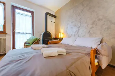 a bedroom with a large bed with towels on it at Sasso Bianco Home - Mountain View & Private Parking in Sottoguda