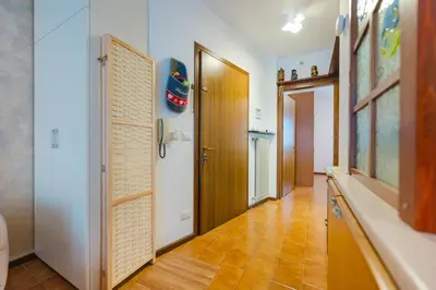 a hallway with a door and a room with a floor at Sasso Bianco Home - Mountain View & Private Parking in Sottoguda