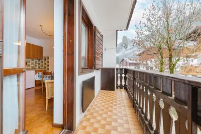 a balcony with a view of a building at Sasso Bianco Home - Mountain View & Private Parking in Sottoguda