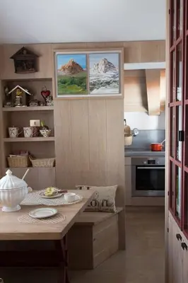 a kitchen with a table and a counter top at Cortina Olympics cosy apartment in Cortina dʼAmpezzo
