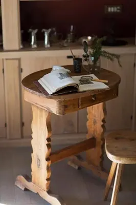 a wooden table with an open book on it at Cortina Olympics cosy apartment in Cortina dʼAmpezzo