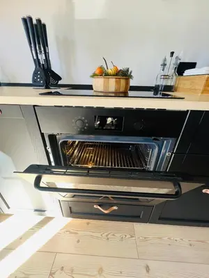 an oven with a bowl of tomatoes on top of it at MH Luxury Apartments in Cavalese