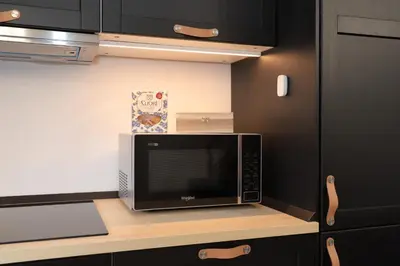 a microwave sitting on a counter in a kitchen at MH Luxury Apartments in Cavalese