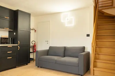 a living room with a couch and a microwave at MH Luxury Apartments in Cavalese