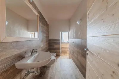 a bathroom with a sink and a mirror at Casa Scola in Falcade
