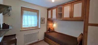 a small room with a couch and a window at Casa Aloch da Aldo Gianni in Pozza di Fassa