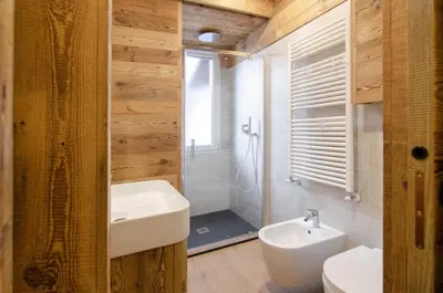 a bathroom with a sink and a toilet and a shower at Casa Gerda nel cuore di Cortina d'Ampezzo in Cortina dʼAmpezzo