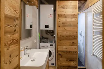 a bathroom with a sink and a washing machine at Casa Gerda nel cuore di Cortina d'Ampezzo in Cortina dʼAmpezzo