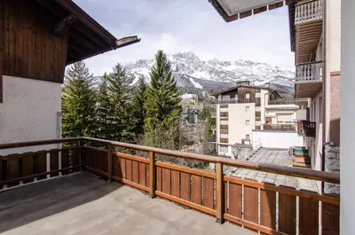 a balcony with a view of the mountains at Casa Gerda nel cuore di Cortina d'Ampezzo in Cortina dʼAmpezzo