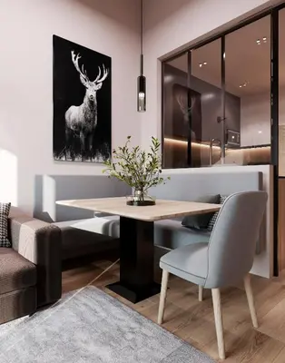 a dining room with a table and a deer picture at Mountain Chalet Costes in San Cassiano