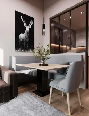 a dining room with a table and a picture of a deer at Mountain Chalet Costes in San Cassiano