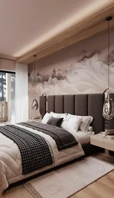 a bedroom with a large bed with a painting on the wall at Mountain Chalet Costes in San Cassiano