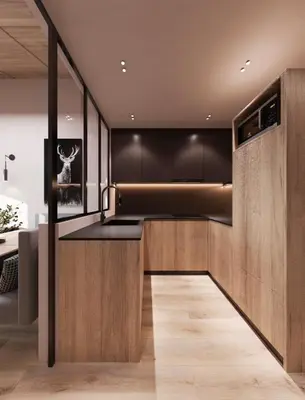 a kitchen with black walls and wooden cabinets at Mountain Chalet Costes in San Cassiano