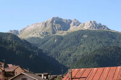 a mountain in the distance with a town and houses at Casa Basilio in Predazzo